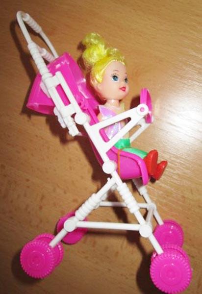 Plastic doll with toy pushchair