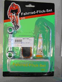Rubber solution in bike repair set containing rubber solution, spanner and several plasters, 'Fahrrad Flick' set