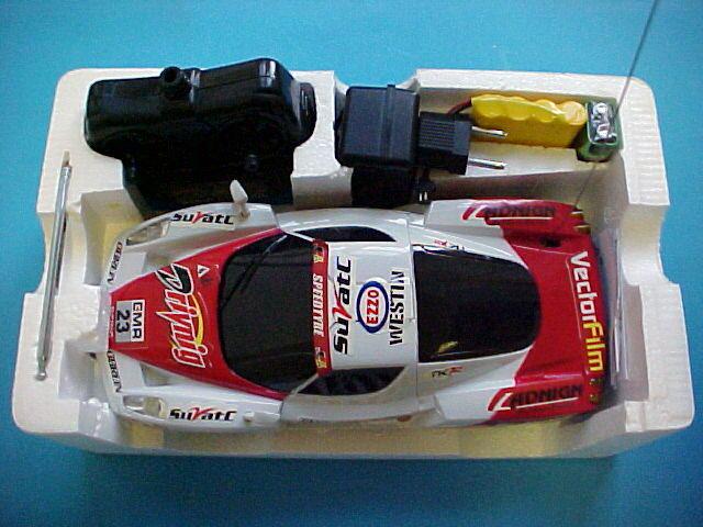 Radio-controlled toy car with remote control and battery charger.