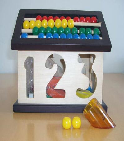 Wooden house with numbers and abacus