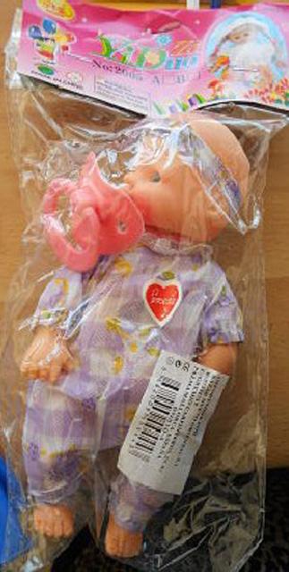 Plastic doll with soother