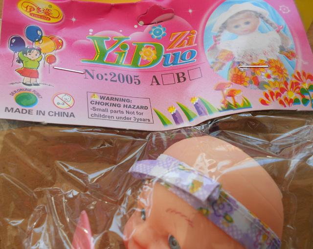 Plastic doll with soother